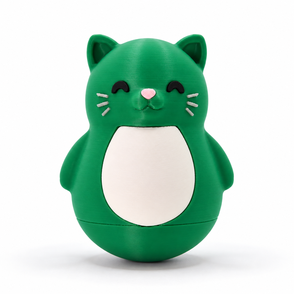 A green cat-shaped container or toy with a white belly, black closed eyes, and a small pink nose, photographed on a clean white background.