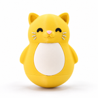 A yellow cat-shaped container or toy with a white belly panel, black closed eyes, a pink nose, and small white whiskers, photographed on a clean white background.