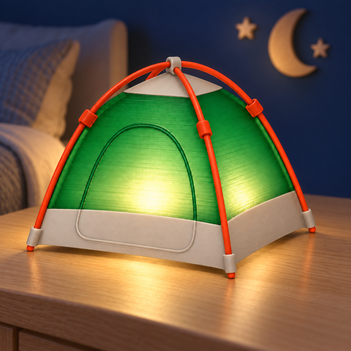 A small dome-shaped camping tent lamp with a green illuminated canopy, orange frame, and white base, placed on a wooden bedside table in a bedroom setting.