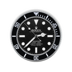 A circular wall clock styled as a Rolex Submariner, featuring a black dial and bezel, silver-tone hands and markers, and a textured silver outer bezel, shown against a plain white background.
