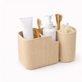 Beige bathroom caddy with toiletries including a toothbrush, toothpaste, and soap on a white background
